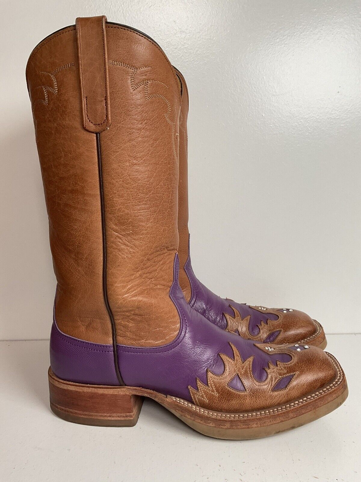 Size 7 B custom cowgirl boots by Anderson Bean, in purple with a crepe sole and tooled wingtip overlay, blending style and comfort.